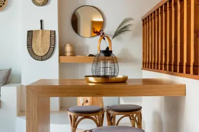 a table with two stools and a mirror at Voyaz Boutique Apartments & Suites -Old Town in Rhodes Town