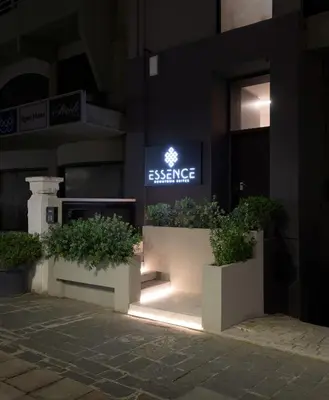 a sign on the side of a building with plants at Essence Suites Downtown Suites - Adults Only in Rhodes Town