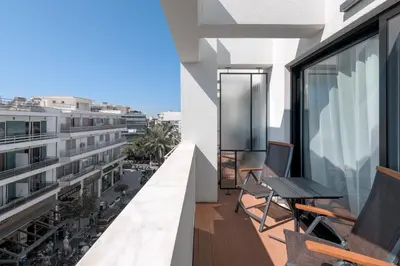 a balcony with a table and chairs on a building at Essence Suites Downtown Suites - Adults Only in Rhodes Town