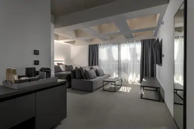 a living room with a couch and a table at Essence Suites Downtown Suites - Adults Only in Rhodes Town