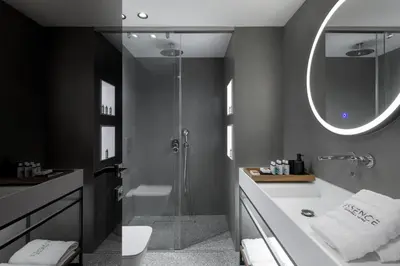 a bathroom with a tub and a shower with a mirror at Essence Suites Downtown Suites - Adults Only in Rhodes Town