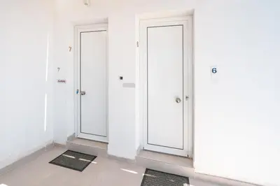 two doors in a room with white walls at CrossRhodes Villas in Pefki Rhodes
