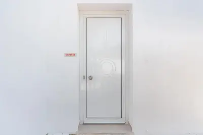 a white door with a sign on it at CrossRhodes Villas in Pefki Rhodes