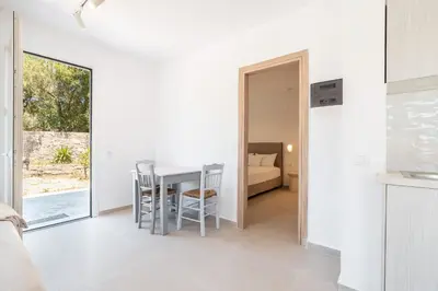 a kitchen and living room with a table and chairs at CrossRhodes Villas in Pefki Rhodes