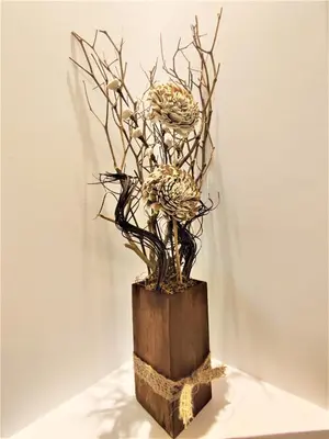 a sculpture of dried flowers in a wooden vase at Villa Pavlina in Ixia