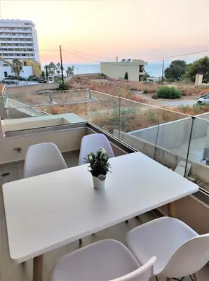 a white table and chairs on a balcony at Villa Pavlina in Ixia