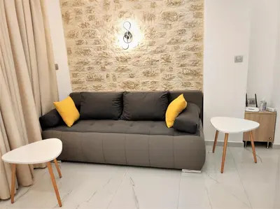 a living room with a couch and two tables at Villa Pavlina in Ixia