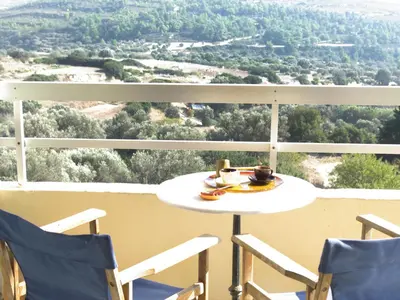 a table and chairs on a balcony with a view at Thomas Hotel in Monólithos