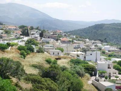a town on a hill with mountains in the background at Thomas Hotel in Monólithos