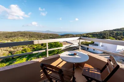 a balcony with a table and chairs and a view at Thomas Hotel in Monólithos