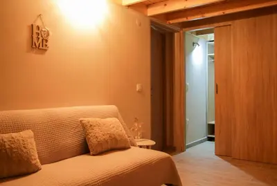 a bedroom with a bed and a light on the wall at AFANDOU NANA'S HOUSE in Afantou
