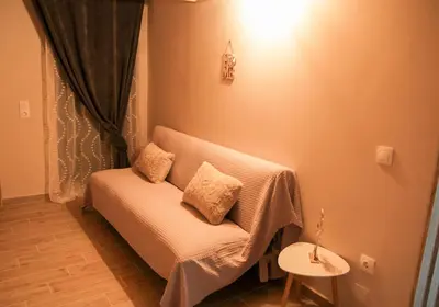 a room with a couch with two pillows on it at AFANDOU NANA'S HOUSE in Afantou