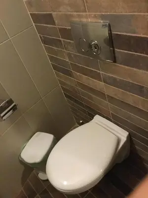 a bathroom with a white toilet and a wall at A medieval windmill tower 2bedrooms in the heart of old town with magnificent panoramic seaview and cityview in Rhodes Town
