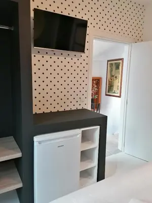 a living room with a tv on a wall with polka dots at Jz Plus Picasso in Rhodes Town