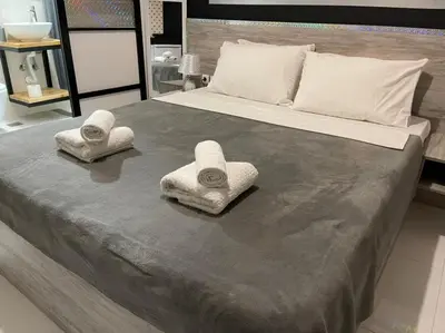 a large bed with two towels on it at Jz Plus Picasso in Rhodes Town