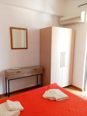 a bedroom with a bed and a dresser and a mirror at Villa Stella Family House in Pefki Rhodes