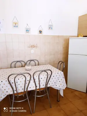 a kitchen with a table with chairs and a refrigerator at Villa Stella Family House in Pefki Rhodes