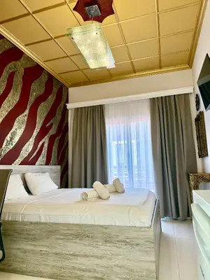 a bedroom with a bed with two towels on it at Jz Plus e'Bella in Rhodes Town