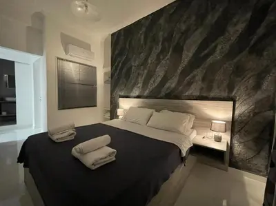 a bedroom with a large bed with two pillows on it at Jz Plus e'Bella in Rhodes Town