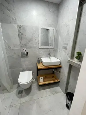 a bathroom with a white toilet and a sink at Jz Plus e'Bella in Rhodes Town