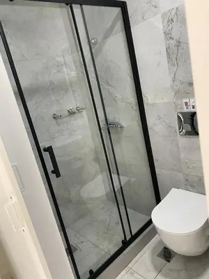 a bathroom with a shower and a toilet at Jz Plus e'Bella in Rhodes Town