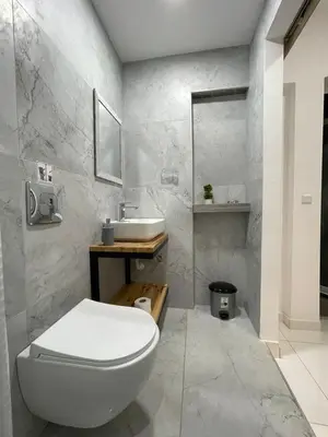 a bathroom with a white toilet and a sink at Jz Plus e'Bella in Rhodes Town