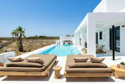 a villa with a swimming pool with two beds at Seacarf Villa, 3 magnificent properties in Lachania beach, Bedrooms 12, Sleeps 27 in Lachania