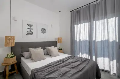 a bedroom with a bed and a large window at Seacarf Villa, 3 magnificent properties in Lachania beach, Bedrooms 12, Sleeps 27 in Lachania