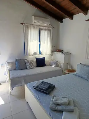 a living room with a bed and a couch at IVISKOS House, Megalo Horio village, Tilos Island in Megálon Choríon