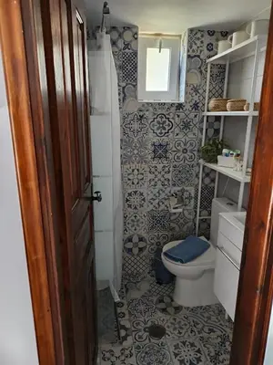 a bathroom with a toilet and a sink at IVISKOS House, Megalo Horio village, Tilos Island in Megálon Choríon