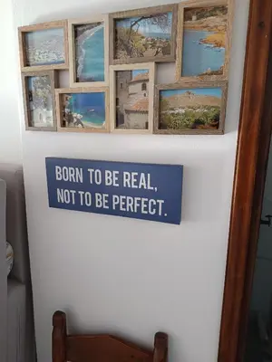 a sign on a wall with pictures on it at IVISKOS House, Megalo Horio village, Tilos Island in Megálon Choríon