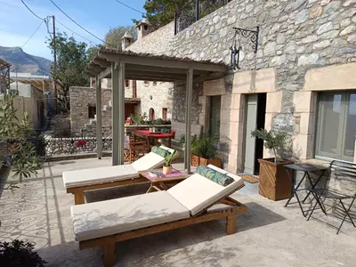 a patio with two white couches and a table at ILAKATI House, Megalo Horio village, Tilos Island in Megálon Choríon