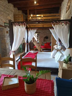 a bedroom with two beds with white mosquito nets at ILAKATI House, Megalo Horio village, Tilos Island in Megálon Choríon