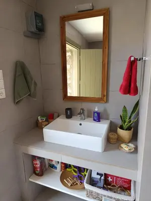 a bathroom with a white sink and a mirror at ILAKATI House, Megalo Horio village, Tilos Island in Megálon Choríon