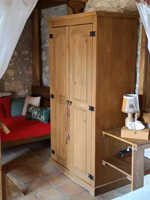 a wooden cabinet with a red couch in a room at ILAKATI House, Megalo Horio village, Tilos Island in Megálon Choríon
