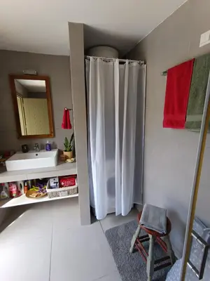 a bathroom with a white shower curtain and a sink at ILAKATI House, Megalo Horio village, Tilos Island in Megálon Choríon