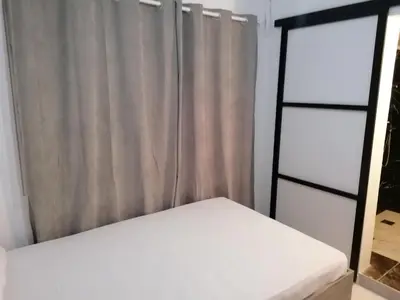a bedroom with two beds and a window at Jz Plus Classio in Rhodes Town