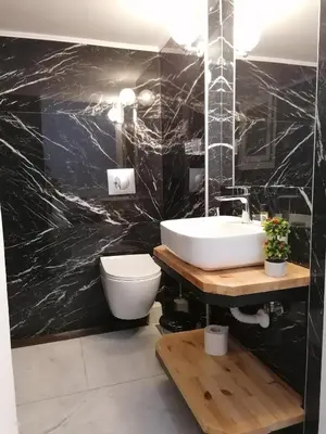 a bathroom with a white sink and a toilet at Jz Plus Classio in Rhodes Town