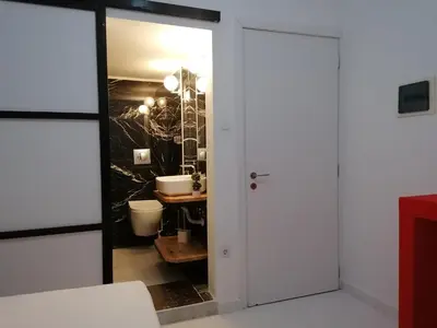 a bathroom with a mirror and a sink at Jz Plus Classio in Rhodes Town