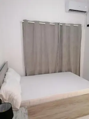 a bed in a room with a curtain at Jz Plus Classio in Rhodes Town