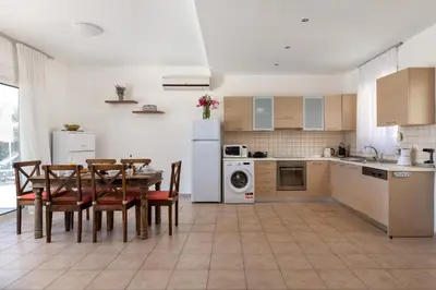 a kitchen and dining room with a table and chairs at Lindos Villa Fadia with Private Pool in Líndos