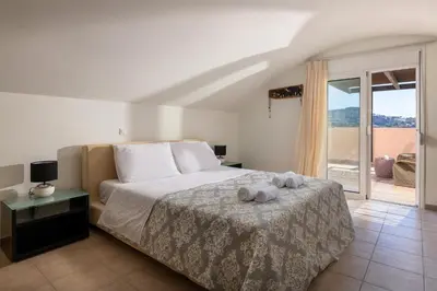 a bedroom with a bed with two towels on it at Lindos Villa Fadia with Private Pool in Líndos
