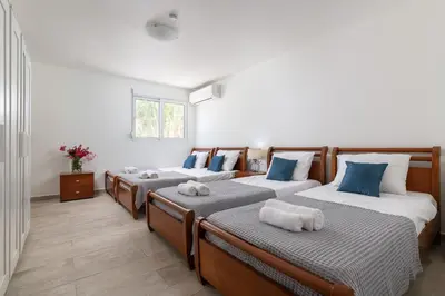 a room with four beds with towels on them at Lindos Villa Fadia with Private Pool in Líndos