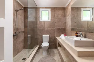a bathroom with a toilet and a sink and a shower at Lindos Villa Fadia with Private Pool in Líndos