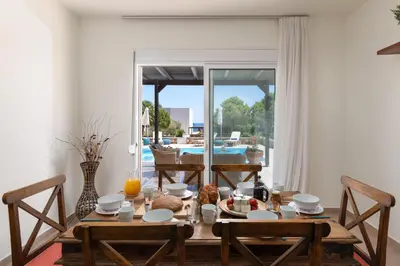 a dining room with a table with food on it at Lindos Villa Fadia with Private Pool in Líndos