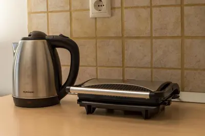 a tea kettle sitting on top of a counter at Economisa Apartments in Ialyssos