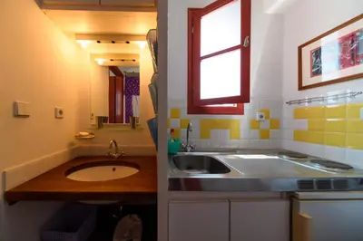 a small kitchen with a sink and a window at Aphrodite Villas Halki - Studio Rosa in Halki