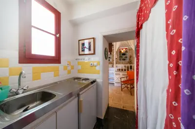 a kitchen with a sink and a window at Aphrodite Villas Halki - Studio Rosa in Halki