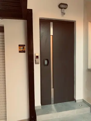 a black door in a building with a sign on it at Cozy Violeta in Ialyssos
