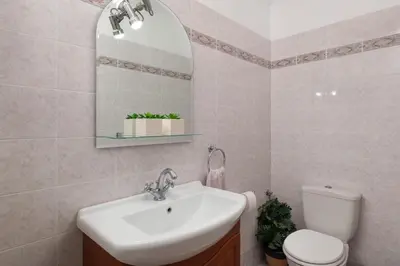 a bathroom with a sink and a toilet and a mirror at Villa Montefile in Triánta